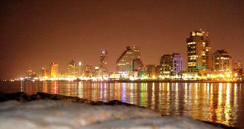Tel Aviv city skyline at night with illuminated buildings